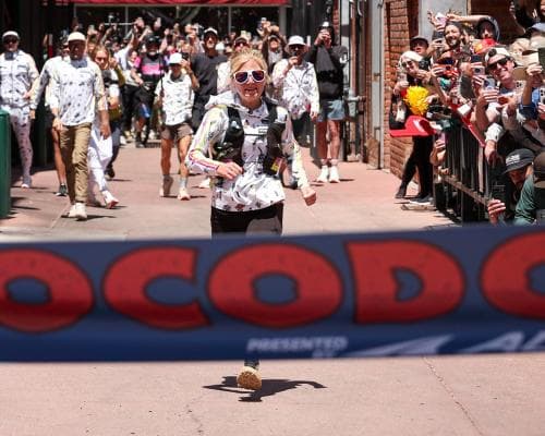 Rachel Entrekin becomes first woman to win Cocodona 250 ultramarathon – and pets dogs along the way